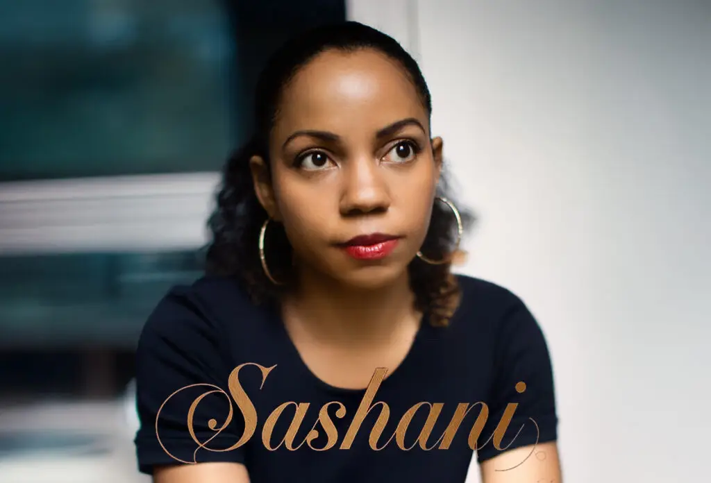 Portrait of singer Sashani wearing a dark navy shirt